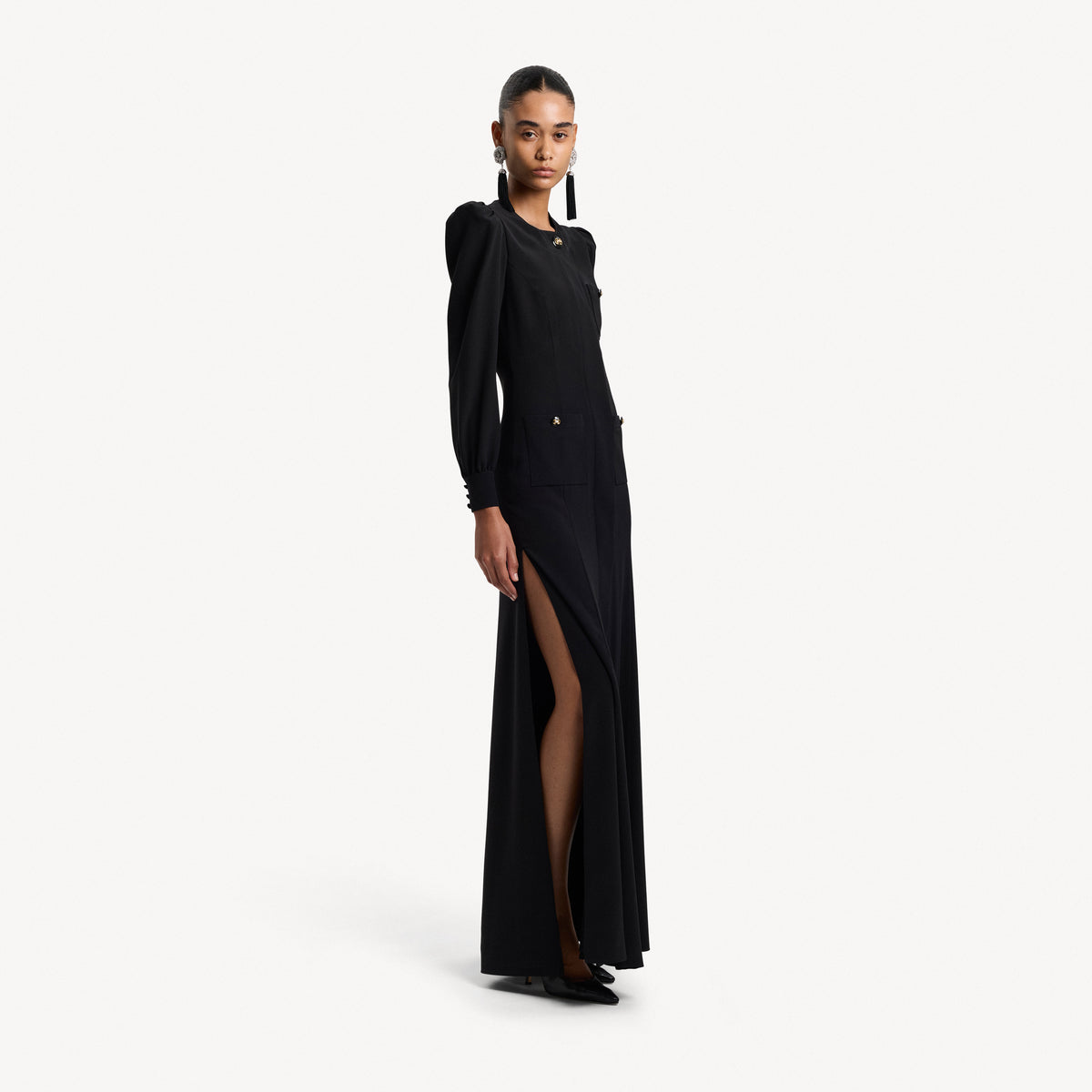 Black silk crêpe de chine evening dress with high side splits and puffed long sleeves, featuring pockets and jewel buttons.

Look 9 – Spring Summer 2027 Lookbook