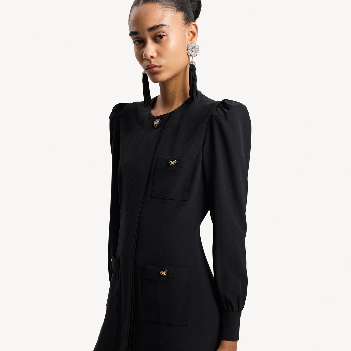 Black silk crêpe de chine evening dress with high side splits and puffed long sleeves, featuring pockets and jewel buttons.

Look 9 – Spring Summer 2027 Lookbook