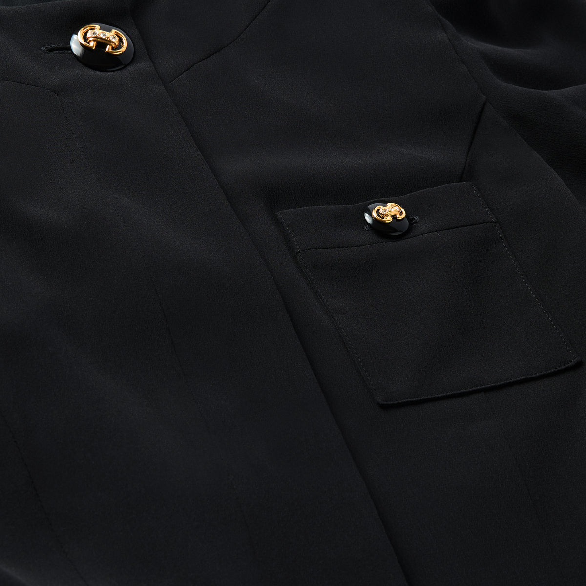 Black silk crêpe de chine evening dress with high side splits and puffed long sleeves, featuring pockets and jewel buttons.

Look 9 – Spring Summer 2027 Lookbook