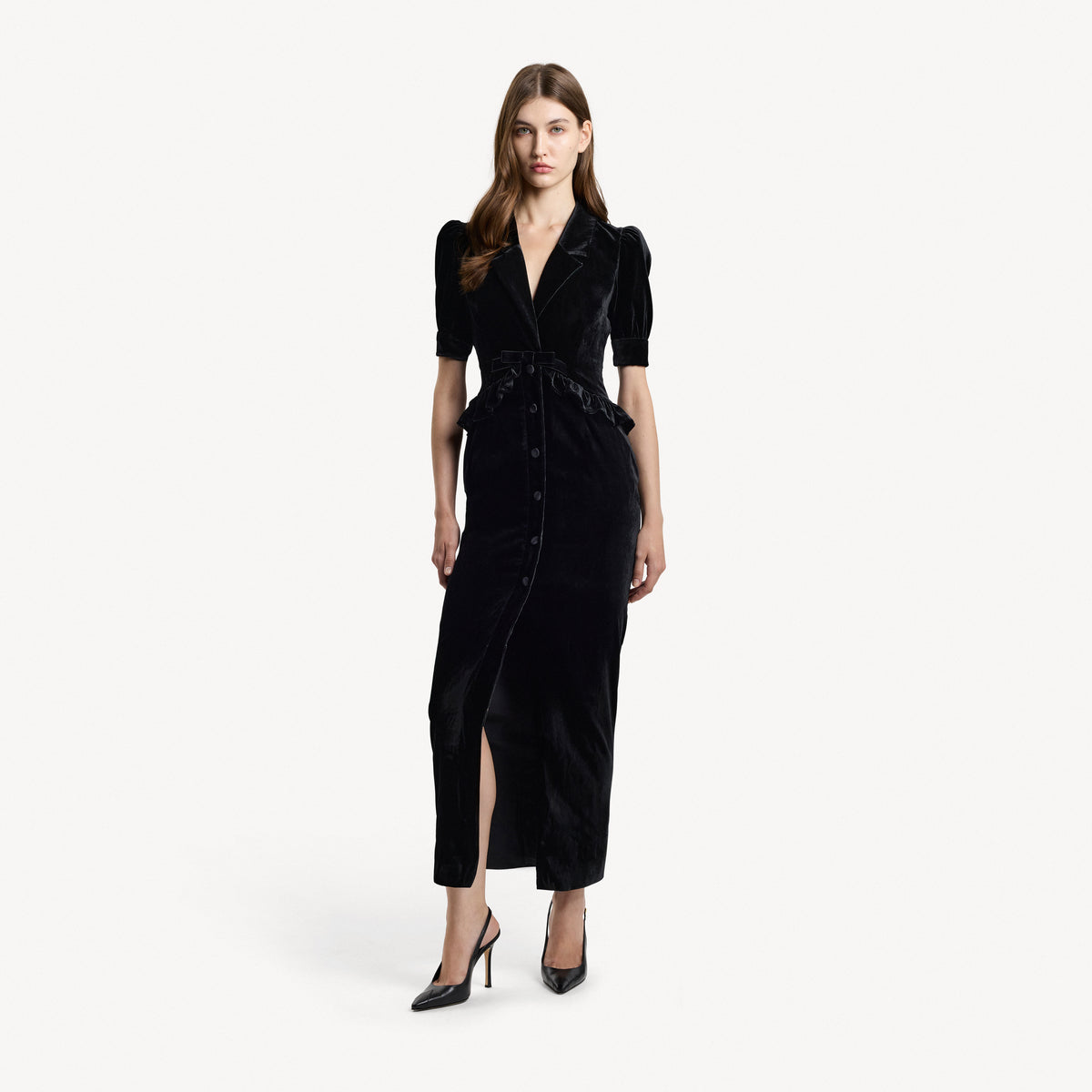 Black velvet evening dress with a v-neckline collar and a back-zip closure, featuring velvet ruffle trims.