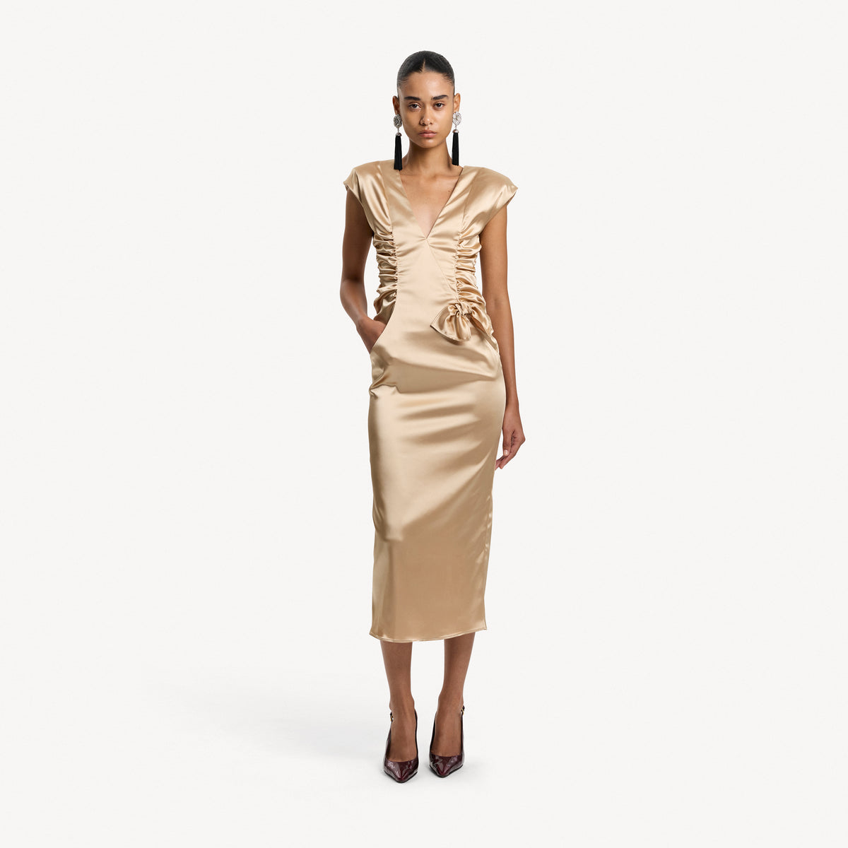 Champagne stretch duchesse midi dress with a ruched bodice and shoulder pads, featuring a bow detail and pockets.

Look 6 – Spring Summer 2027 Lookbook